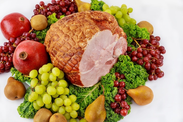 Whole pork ham with fresh fruits. Healthy food. Easter meal.