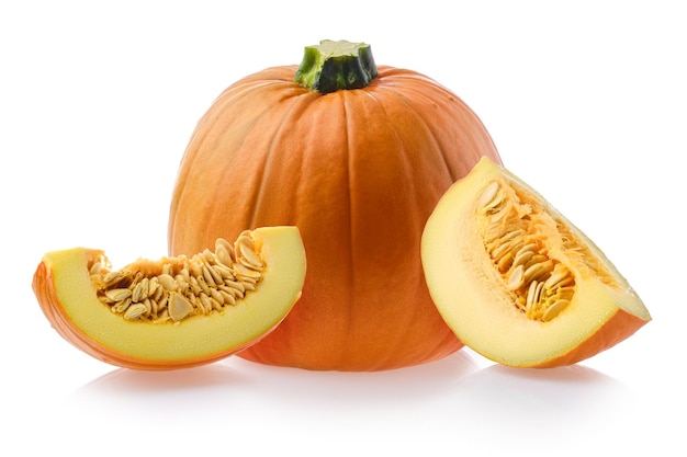 Whole pumpkin cut on half and on slices isolated on white