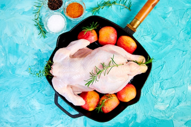 Whole raw chicken with ingredients. Cooking .