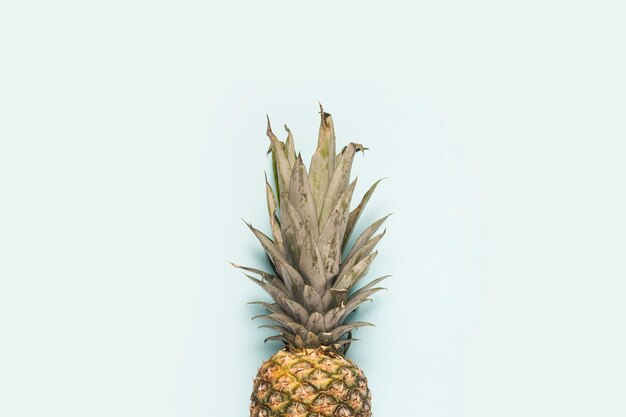 Whole ripe pineapple on a light background