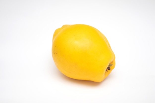 Whole ripe yellow quince on a white background