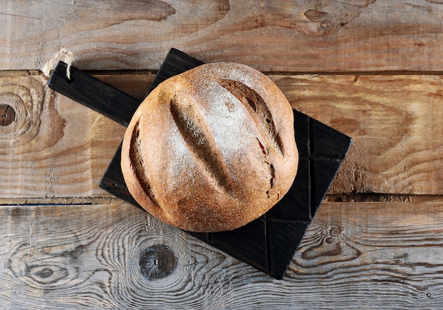 Whole rye bread on wooden Board