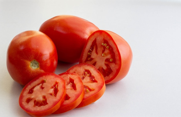 Whole and sliced red tomatoes