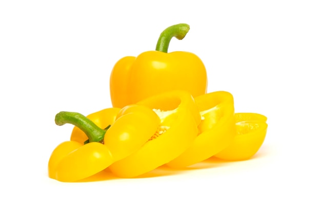 Whole and sliced yellow bell pepper or paprika isolated on white background