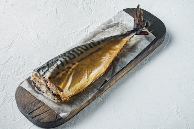 Whole smoked fish mackerel, on white table