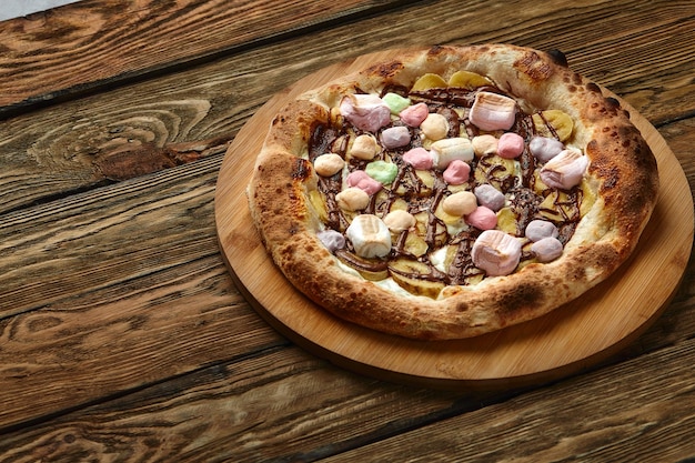 Whole sweet pizza served with marshmallows and candies