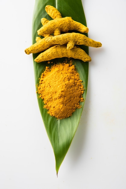 Whole turmeric and haldi or huldi powder heap