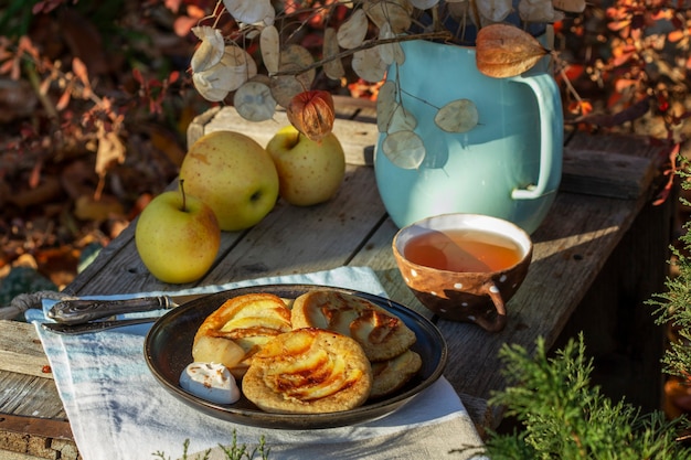 Whole wheat apple pancakes served with tea in the garden rustic style