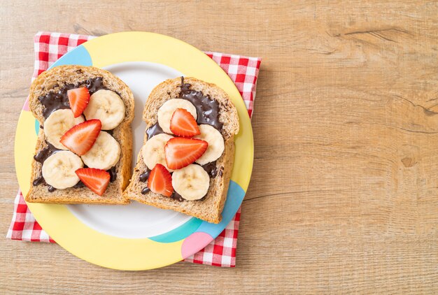 whole wheat bread with fresh banana, strawberry and chocolate