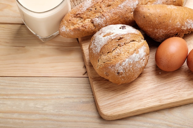 Whole wheat bread on wooden background