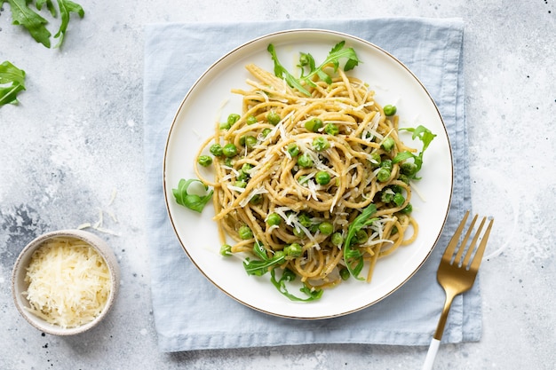 Whole wheat pasta spaghetti with green peas and avocado Italian cuisine