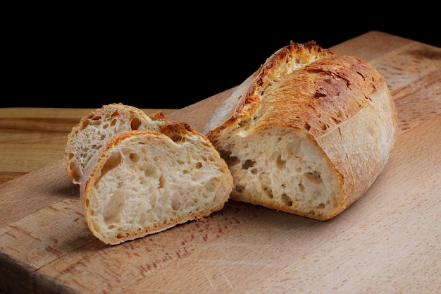 Whole wheat sliced bread on wooden board. Freshly baked traditional bread on wooden table. Healthy food