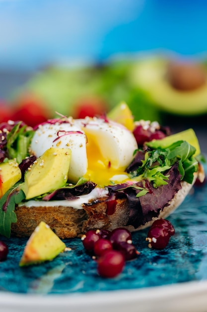 Whole wheat toasted bread with avocado poached egg soft cheese\
and mix salad healthy diet food breakfast