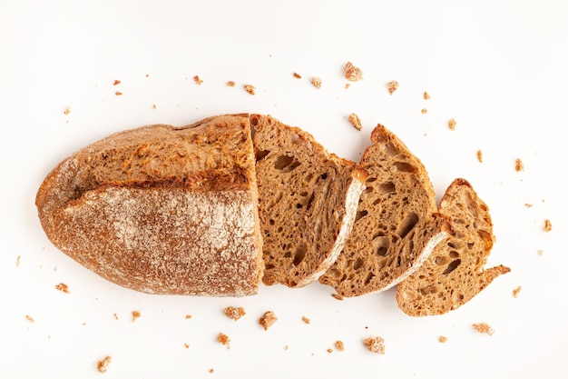 Wholegrain Organic Bread with crumbs isolated on white background Sliced cutted wheat bread