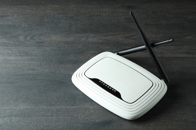 Wi-Fi router with external antennas on dark wooden background