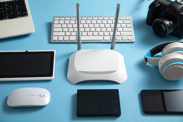 Wi fi router with a tablet phone computer keyboard and other objects