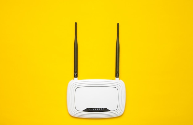 Wi-Fi router on a yellow background. Trend of minimalism. Always online. Top view.