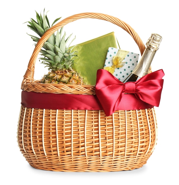 Photo wicker basket full of gifts isolated on white