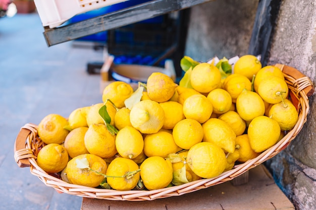 Wicker basket full of lemons on the italian street od Corniglia