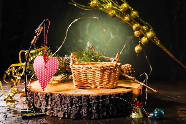 Foto cesto di vimini sul podio casto di vimini e cuore cesto di natale e decorazioni cesto per regali e dolci giocattoli e decorazioni per le vacanze