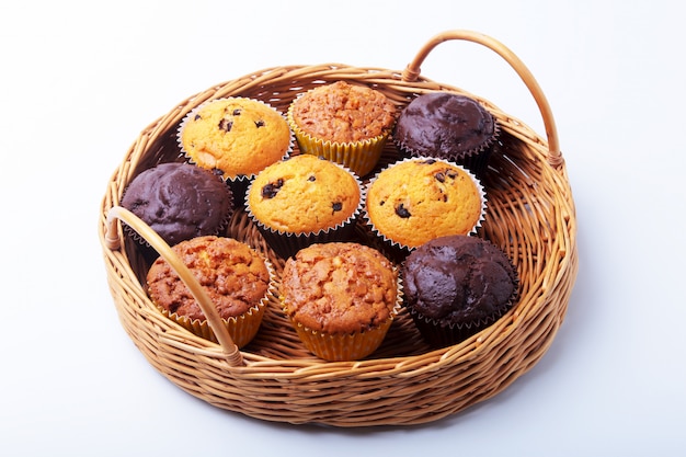 Wicker basket with assorted delicious homemade cupcakes with raisins and chocolate.