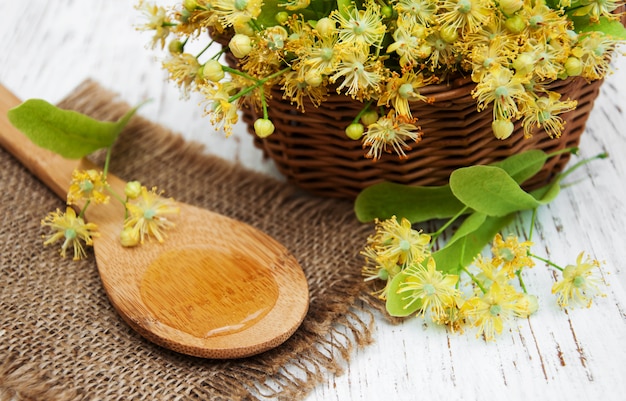 Wicker basket with lime flowers on a table