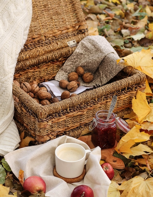 Wicker basket with nuts and a cup of coffee