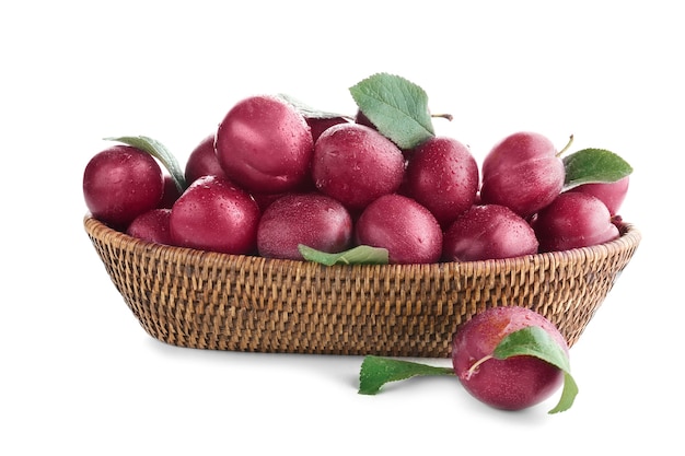 Wicker basket with ripe plums