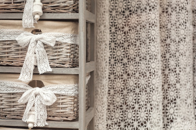 Wicker baskets and crochet curtain