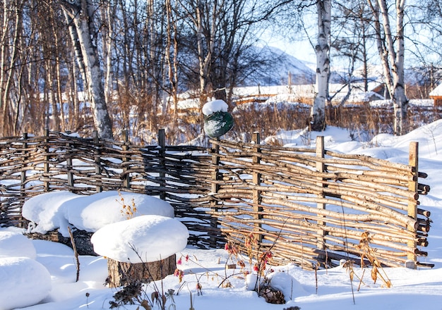 Wicker fence of twigs in winter