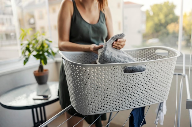 Wicker grey laundry basket on a wire clothesline in focus