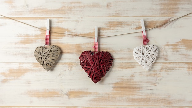 Wicker hearts made of straw hanging on brown rope