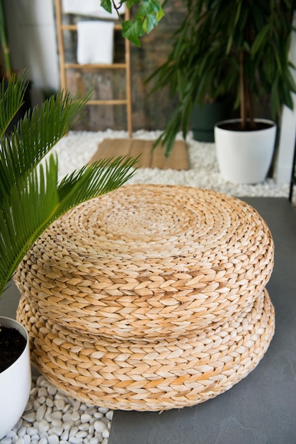 Wicker ottoman in the interior. Wicker furniture made of natural materials. texture of rattan with natural patterns