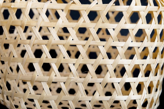 Wicker round bamboo basket on black background