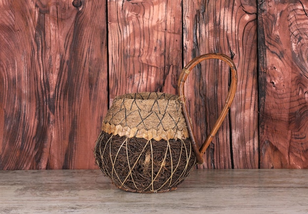 Photo wicker vase on a wooden table