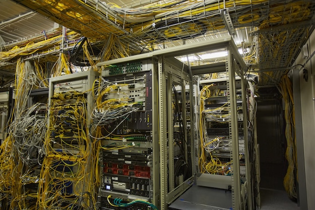 Wide angle background image of server room with internet cables and wires, copy space