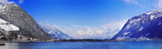 Wide angle panoramic view of zell am see city and lake in winter austria alps