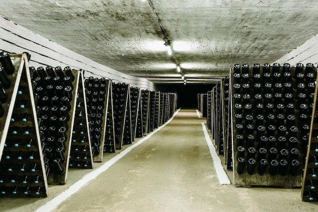 Wide angle photo shot of a winery storage of ready bottles in a tunnel