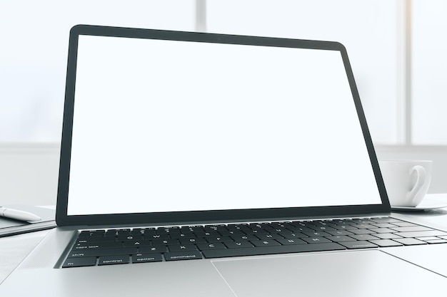 Wide angle shot with blank white modern laptop monitor screen with copyspace for your logo or text on sunny window background 3D rendering mock up