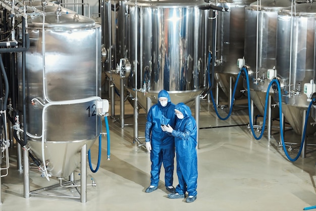 Wide angle view at factory workshop with two workers