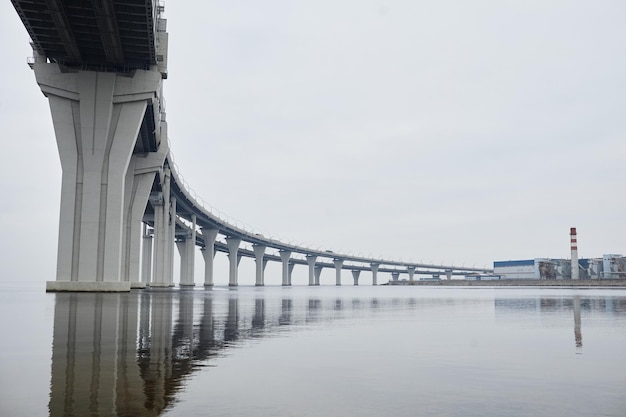 Wide angle view at industrial are with futuristic bridge by water pollution and production concept c...