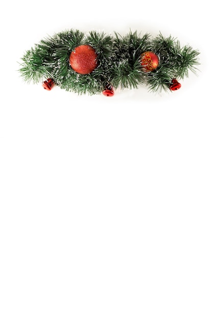 Wide arch shaped Christmas border isolated on white, composed of fresh fir branches and ornaments in red . Christmas tree isolated - Christmas decoration.