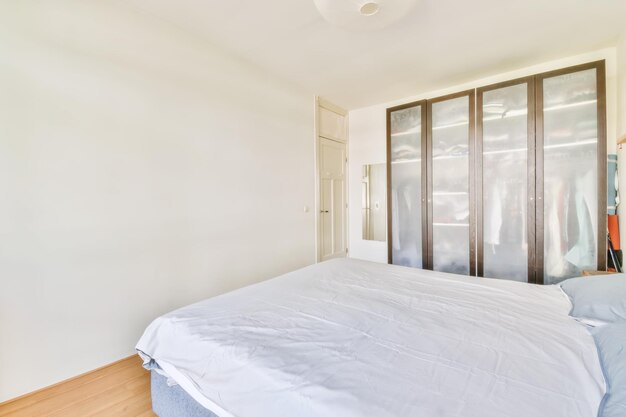 Wide bed in light bedroom