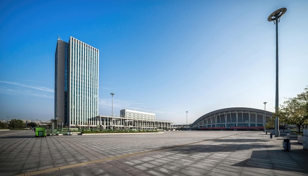 Wide city plaza in early morning light with modern buildings