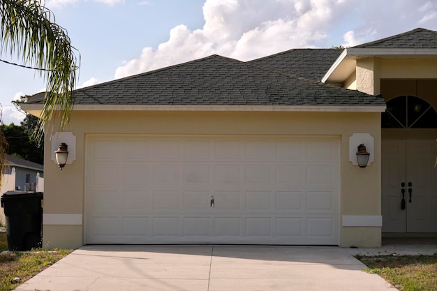 Wide garage double door and concrete driveway of new modern american house