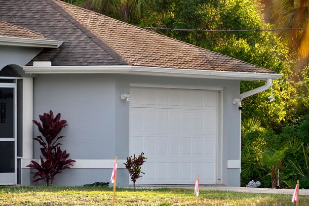 Photo wide garage double door and concrete driveway of new modern american house