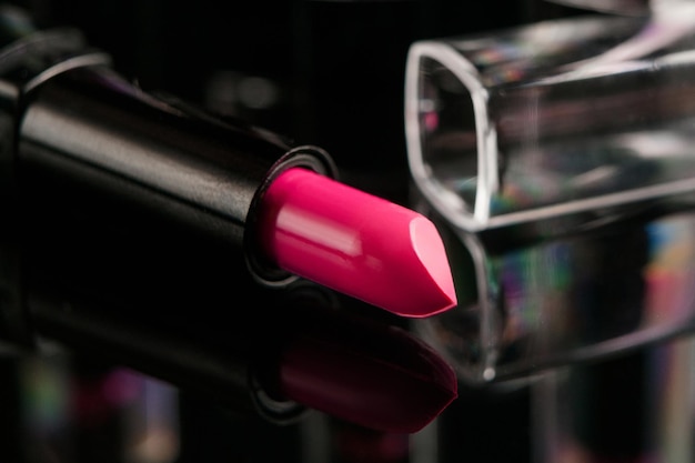 Photo wide range of women's lipsticks on black background. beauty blog. professional make-up courses. free space concept
