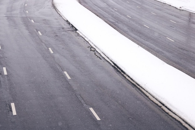 A wide road in the snow in winter