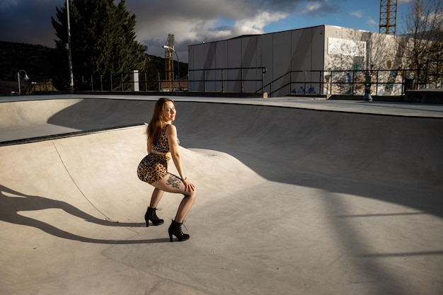 Wide shot of beautiful twerk dancer performing outdoors Portrait of cheerful blond Caucasian woman dancing modern dance