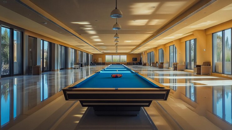 Photo wide shot of a large horizontal room in the middle of the room is a super long and thin billards